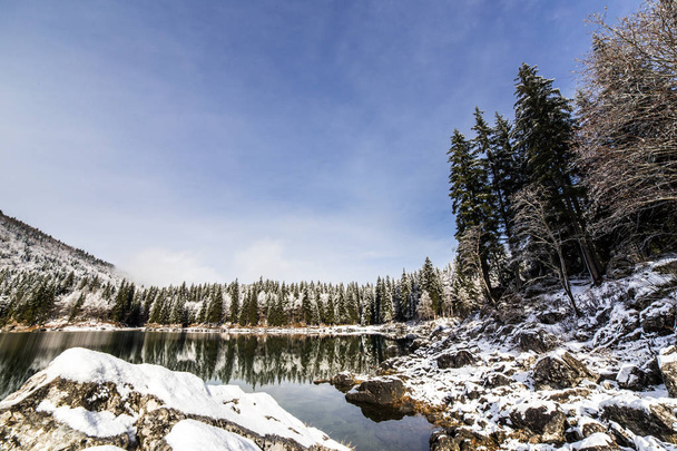 first snow at the mountain lake - Photo, Image