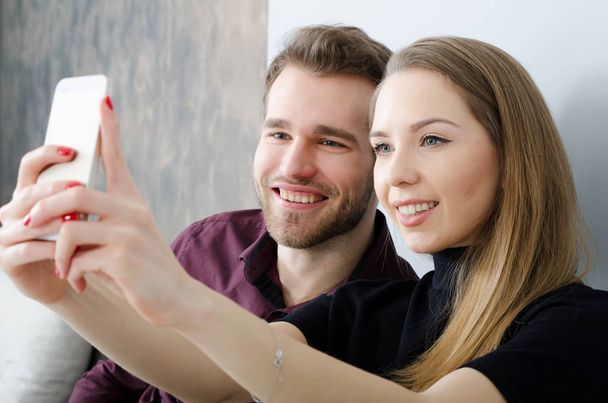Young couple taking a selfie photo - 写真・画像