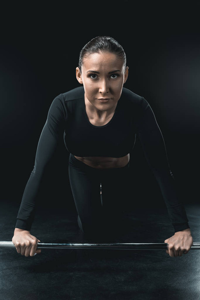 sportswoman training with barbell - Foto, immagini