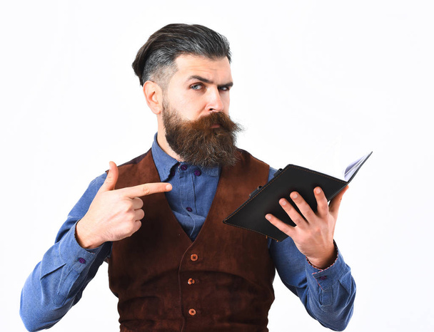 bearded man holding notepad with serious face - Foto, Imagem