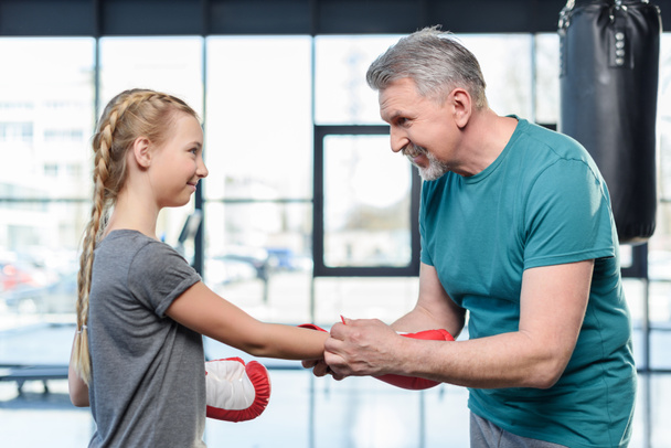 preteen girl boxing with trainer. - Fotoğraf, Görsel