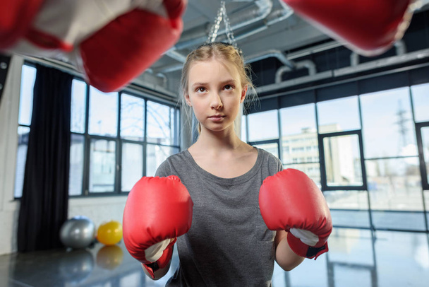 preteen girl boxing with trainer. - Photo, Image