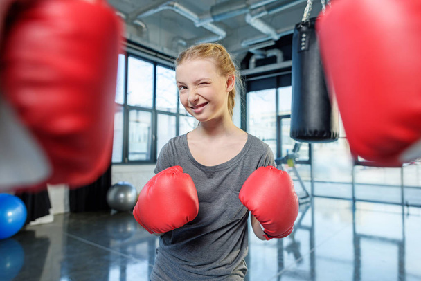 preteen girl boxing with trainer. - Фото, зображення