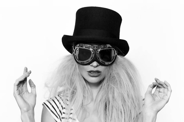 Blonde girl monochrome portrait wearing strange sunglasses and black hat - Foto, afbeelding