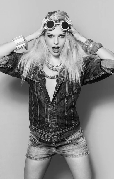 Blonde pop girl wearing jeans jacket and accessories monochrome - Photo, Image