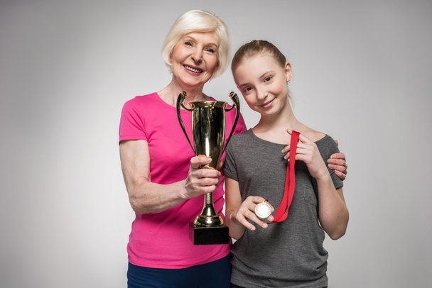 Sporty family with trophy  - Фото, изображение