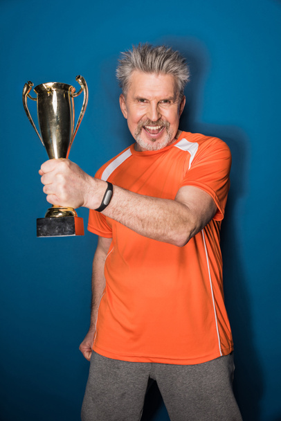 Senior sportsman with trophy   - Valokuva, kuva