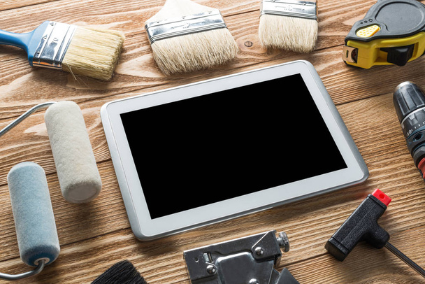 tools of builder and tablet pc on table - Photo, Image