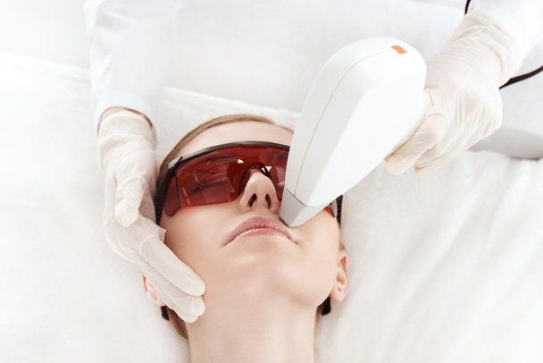 Woman receiving laser treatment  - Фото, изображение