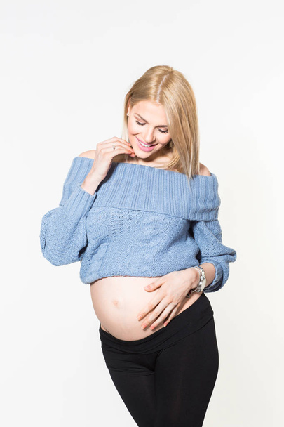 Beautiful young pregnant blonde woman in studio isolated - Foto, Imagem