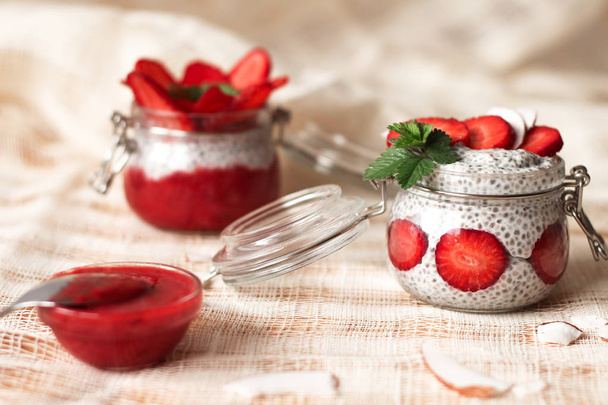 Chia pudding with strawberries in small bowls on a linen tablecloth - Foto, Imagen