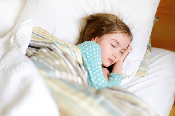 Adorable little girl sleeping in bed - Fotoğraf, Görsel