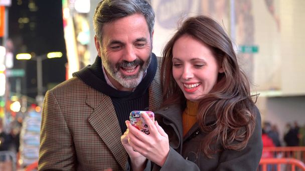 Couple looks at smart phone - Photo, Image