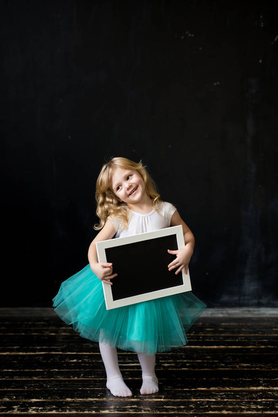 Cute little girl with a frame in her hands - Foto, immagini