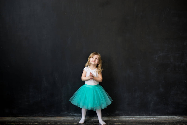 young girl standing in front of chalk board - Photo, Image