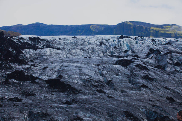 Icelandic Glacier with a group of hikers hiking tourists climbing exploring the famous glacier in Iceland - Photo, image