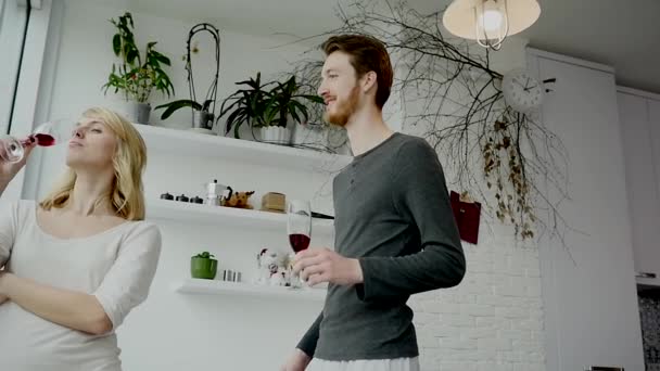 Young couple drinking red wine in the kitchen at home - Video