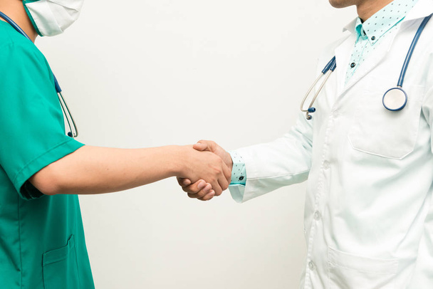 Asian male medical doctors hand shake on white background - Foto, imagen