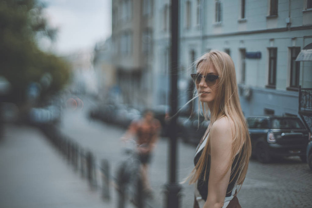 Tilt-shift shooting blonde girl on street - Zdjęcie, obraz
