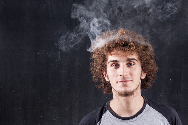 Thinking boy with blackboard and smoking steaming head - Fotoğraf, Görsel