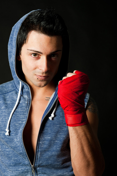 Portrait of young boxer on dark background - Photo, Image