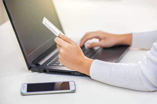 Hands holding credit card and using laptop. Online shopping - Fotografie, Obrázek