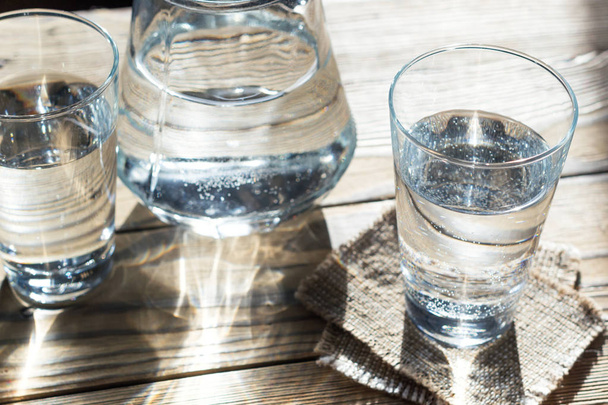 Glasses of water on a wooden table - Фото, изображение