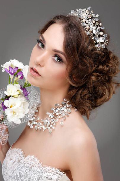 A portrait of elegant girl is in fashion style. Wedding decoration. On a grey background - Фото, зображення