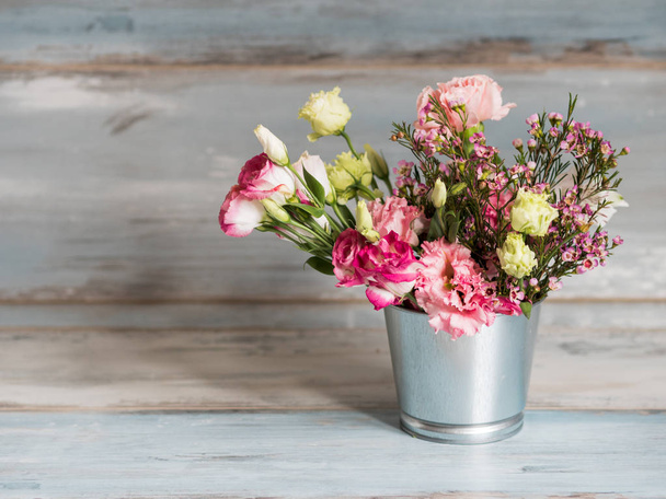 Spring flowers in small tin bucket - Фото, зображення