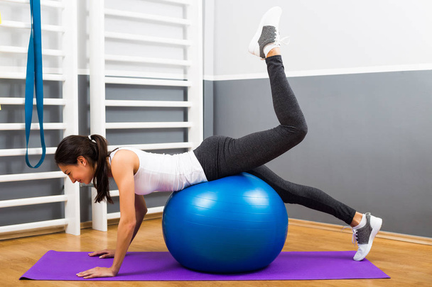 Fitness woman practicing with pilates ball - Foto, imagen