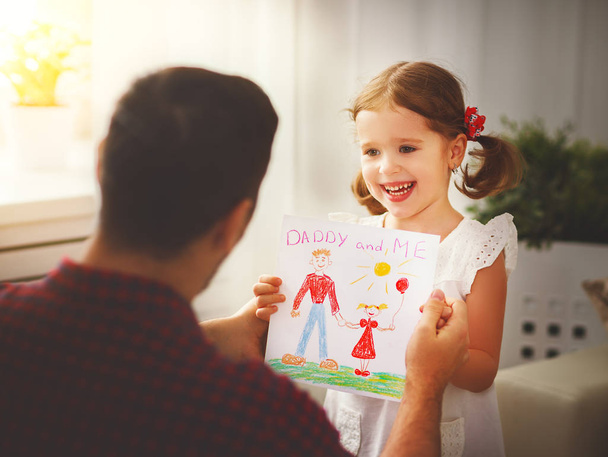 Father's day. Happy family daughter giving dad greeting card  - Photo, image