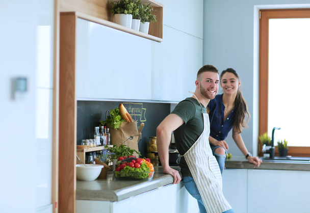 Beautiful young couple is having fun in kitchen at home - Photo, image
