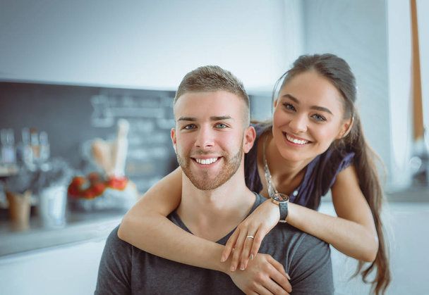 Beautiful young couple is having fun in kitchen at home - Foto, Imagen
