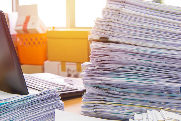 documents on desk stack up high waiting to be managed - Photo, Image