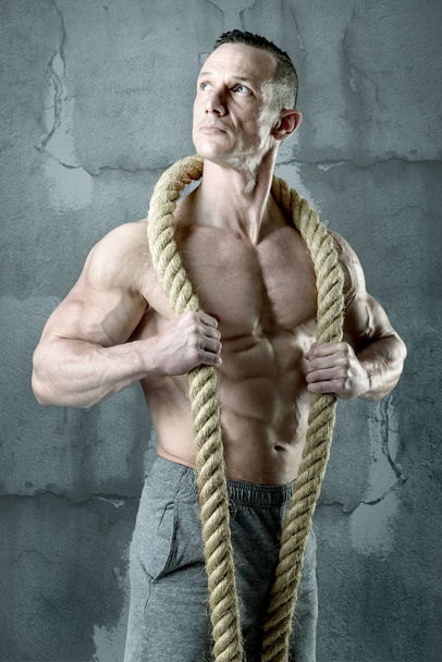 Strong man with rope - Zdjęcie, obraz