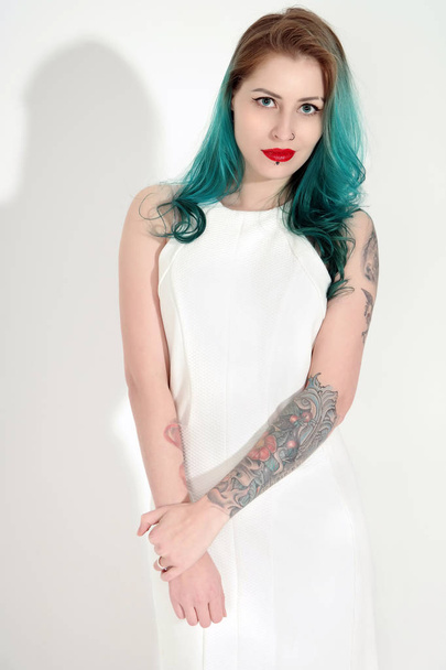 Beautiful tattooed woman with red lipstick isolated on white - Фото, зображення