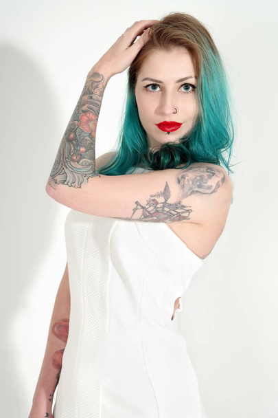 Beautiful tattooed woman with red lipstick isolated on white - Valokuva, kuva