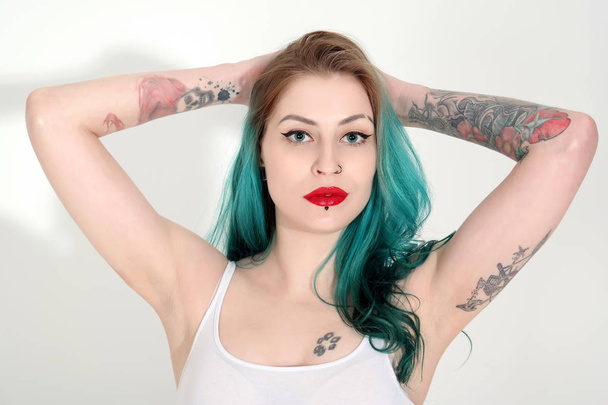 Beautiful tattooed woman with red lipstick isolated on white - 写真・画像