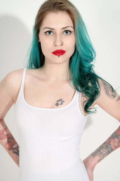 Beautiful tattooed woman with red lipstick isolated on white - Photo, image
