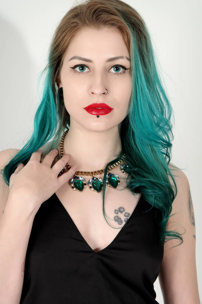 Beautiful tattooed woman with red lipstick isolated on white - Фото, изображение