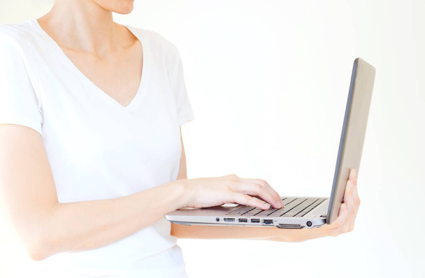 male hand holding a laptop, isolated on white - Φωτογραφία, εικόνα