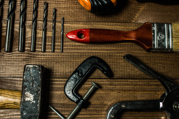 Set of hand tools on a wooden table - 写真・画像