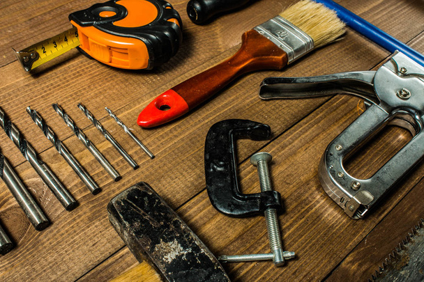 Set of hand tools on a wooden table - Fotó, kép