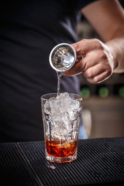 Barman is pouring alcohol - Fotoğraf, Görsel