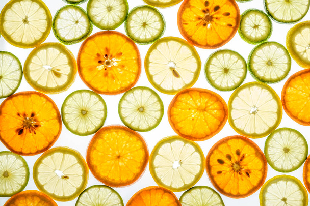 Bright mandarin, lemon and lime slices on white - Фото, изображение