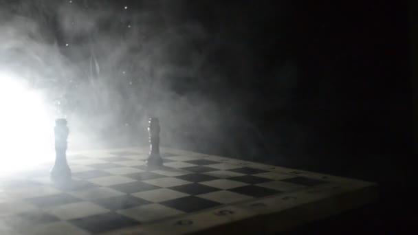 chess board game concept of business ideas and competition and strategy ideas concep. Chess figures on a dark background with smoke and fog. Selective focus - Footage, Video