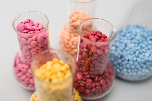 Multicolored pills in glass flasks - Foto, immagini