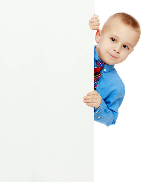 boy peeks out from behind the banner - Fotografie, Obrázek