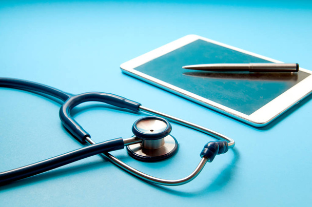 stethoscope, tablet pc on blue color background. Medical technol - Foto, imagen