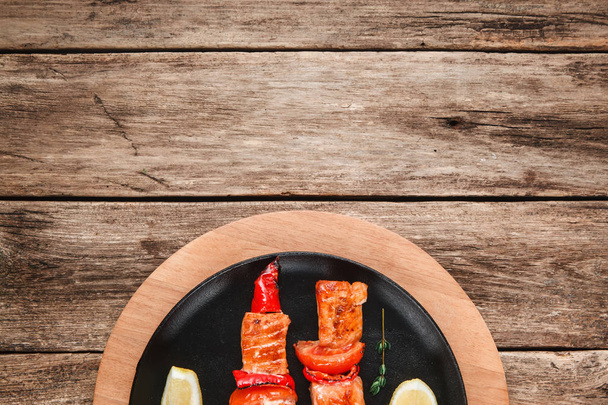 Grilled salmon kebab on wooden table free space - 写真・画像